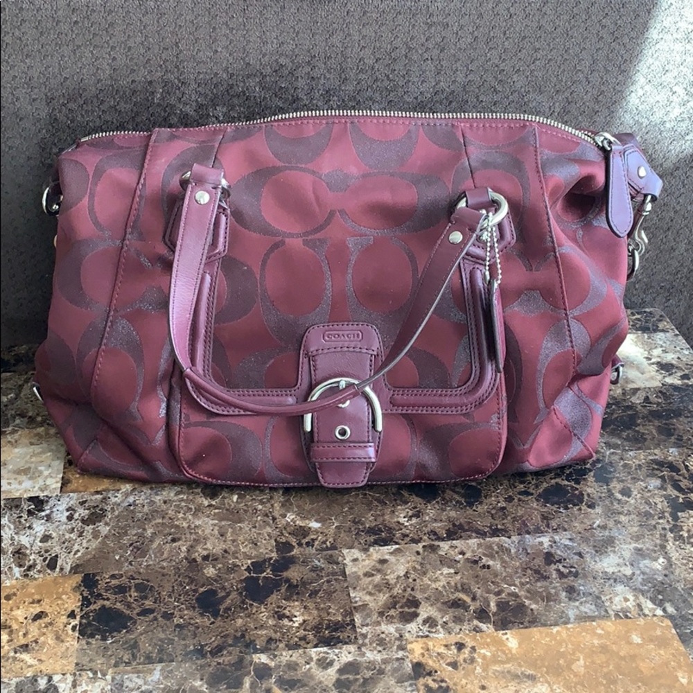 Burgundy coach purse.